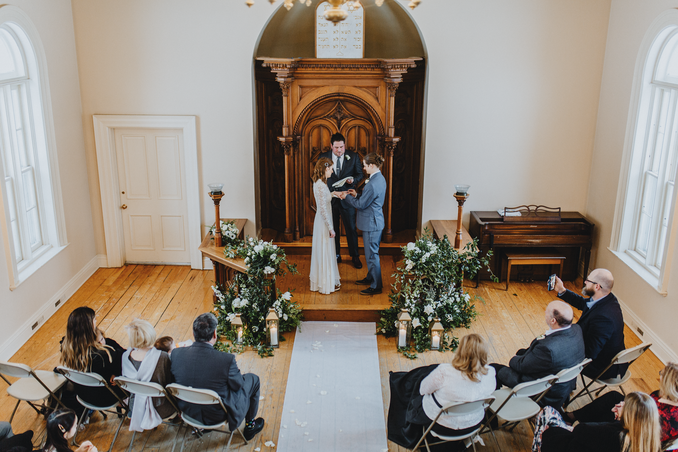 Intimate wedding photography in Madison by Jill Koskelin. Bride and groom exchanging rings during ceremony.